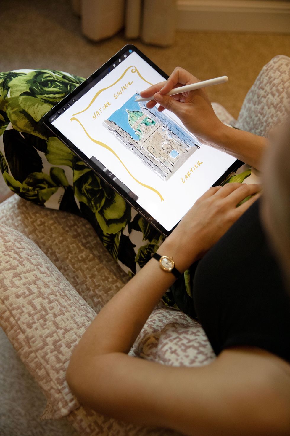 a woman illustrating on an ipad