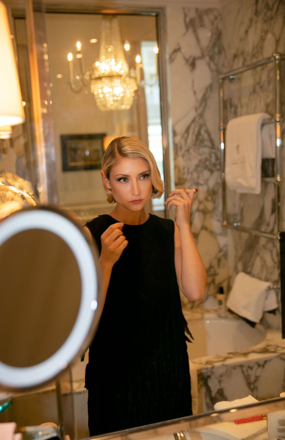 a person in a black dress in a bathroom