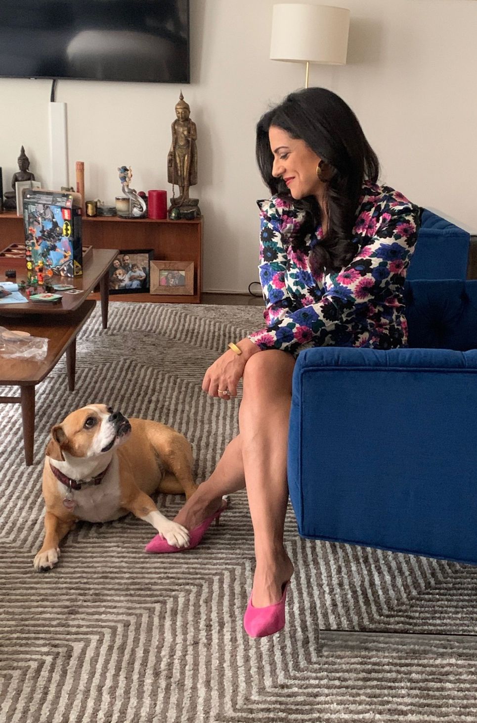 a woman sitting on a couch with a dog