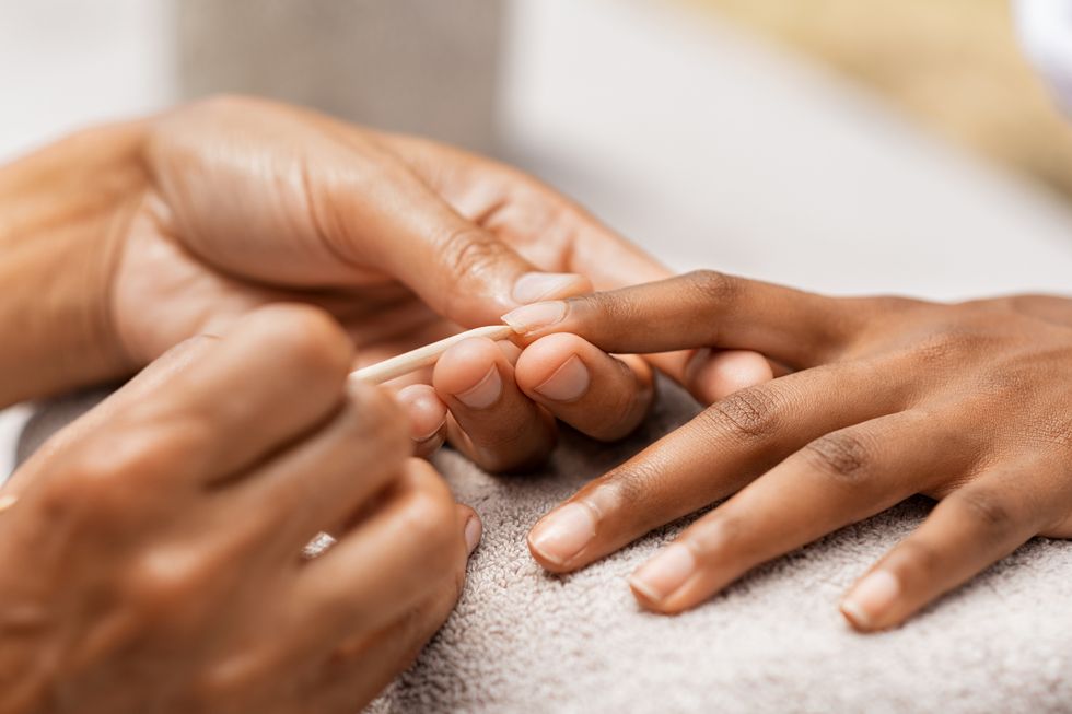 woman getting manicure in spa