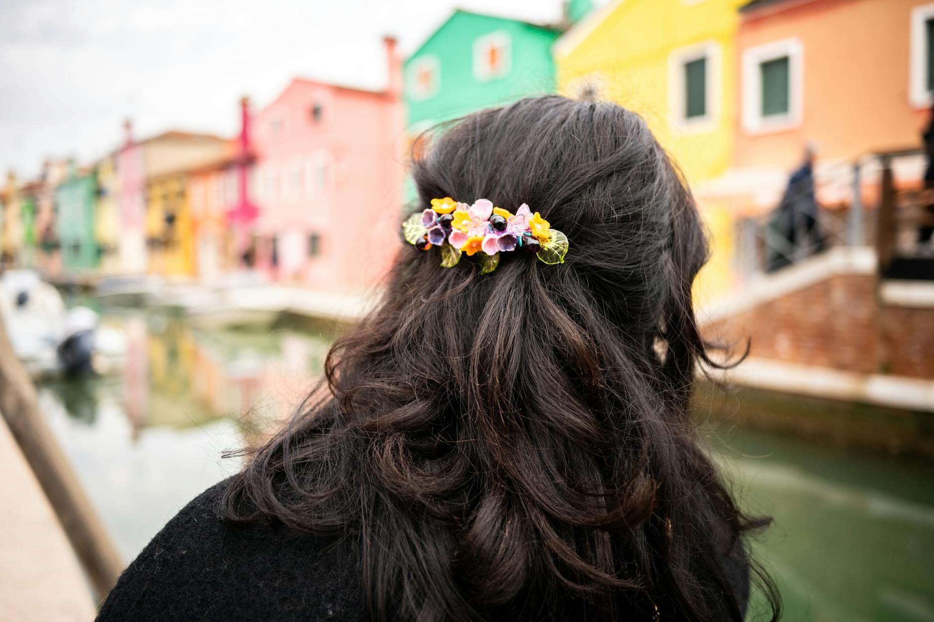 Collection of colorful hair accessories including clips and scrunchies arranged on a light surface