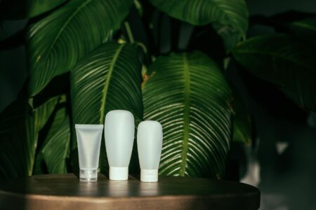 Why Beauty Brands Are Launching Refillable Packaging Only Product Lines Various refillable cosmetic containers and compacts arranged on a clean surface