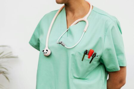 Healthcare professional wearing medical scrubs in clinical setting
