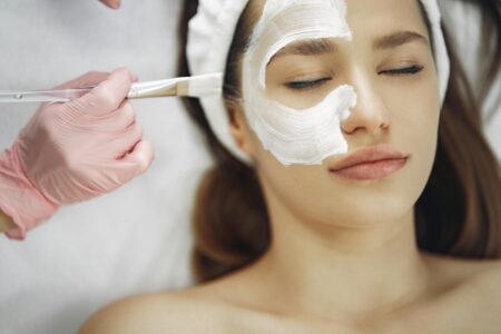 Woman receiving professional facial treatment at modern spa