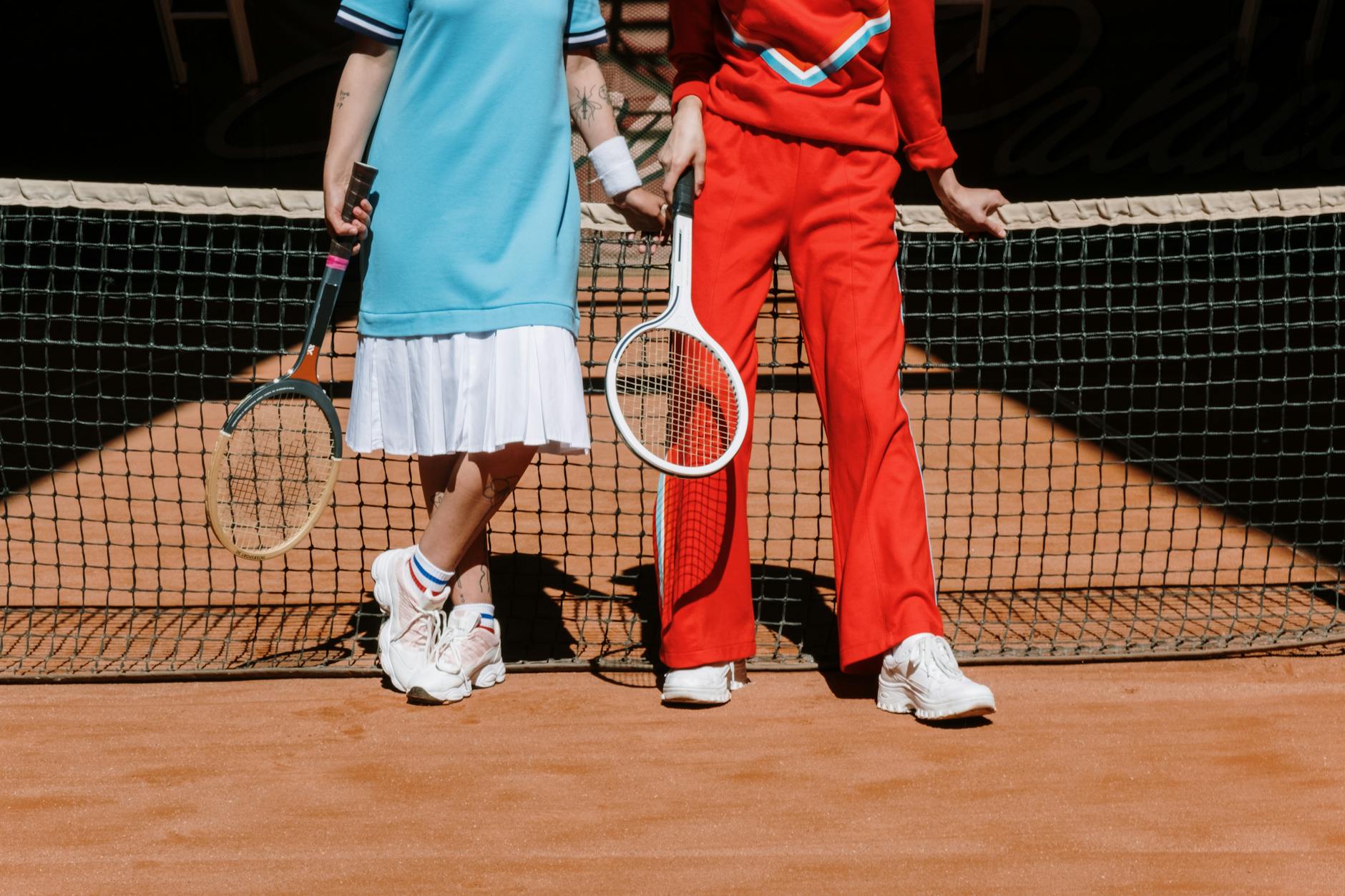 Athletic wear displayed on tennis court showing coordinated sports clothing and accessories