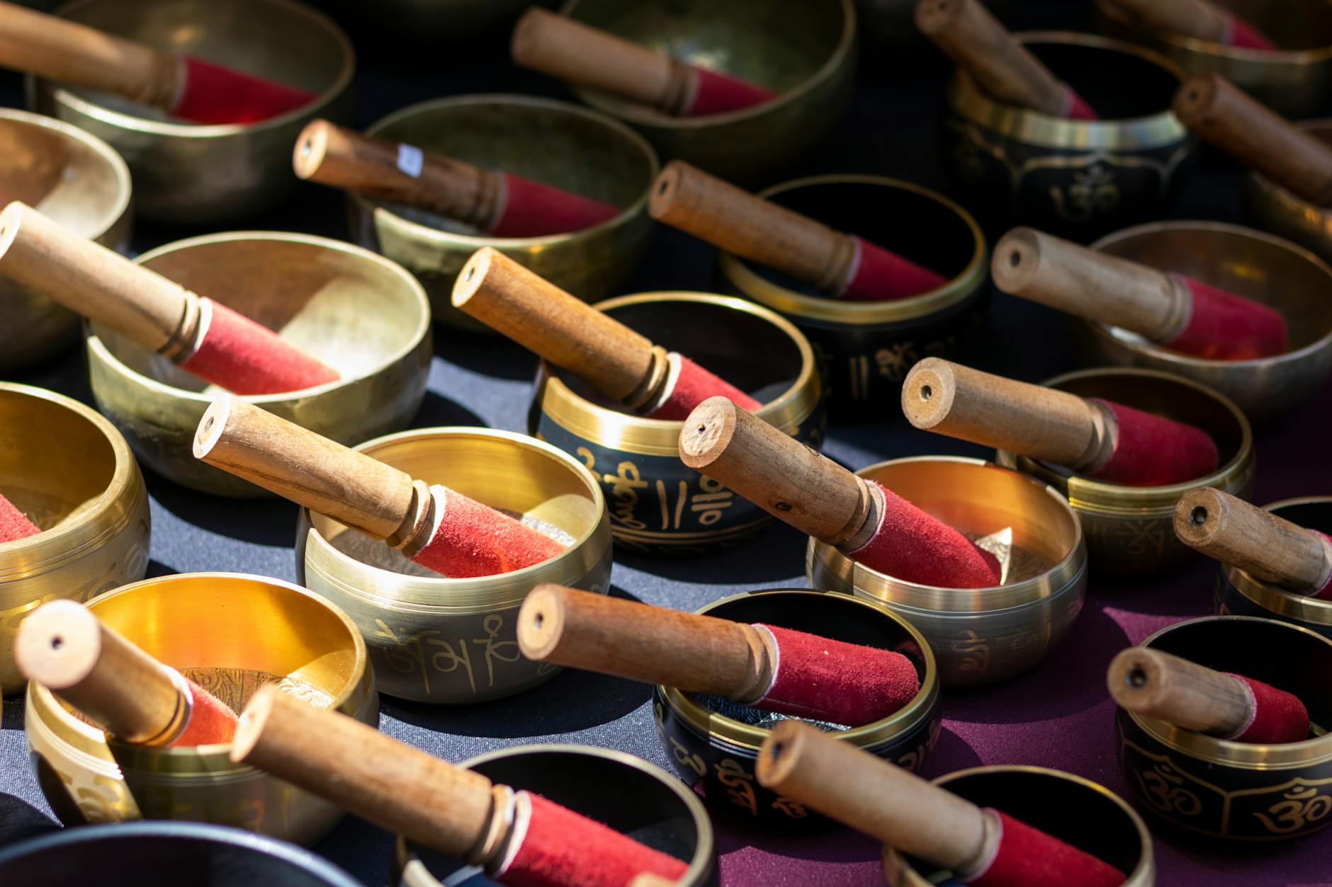 Tibetan singing bowls arranged on wooden surface in spa setting