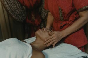 Why Lymphatic Drainage Facials Are Replacing Botox in Hollywood Professional esthetician performing gentle facial massage on client in spa setting