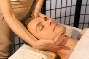 How Massage Therapists Are Adding Gua Sha to Professional Facial Services Professional massage therapist performing facial treatment on client in spa setting