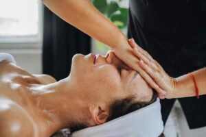 How Reflexologists Are Adding Facial Pressure Points to Anti-Aging Treatments Professional facial massage treatment showing pressure point technique application