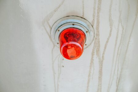 Modern red light therapy device glowing in a clean bathroom setting