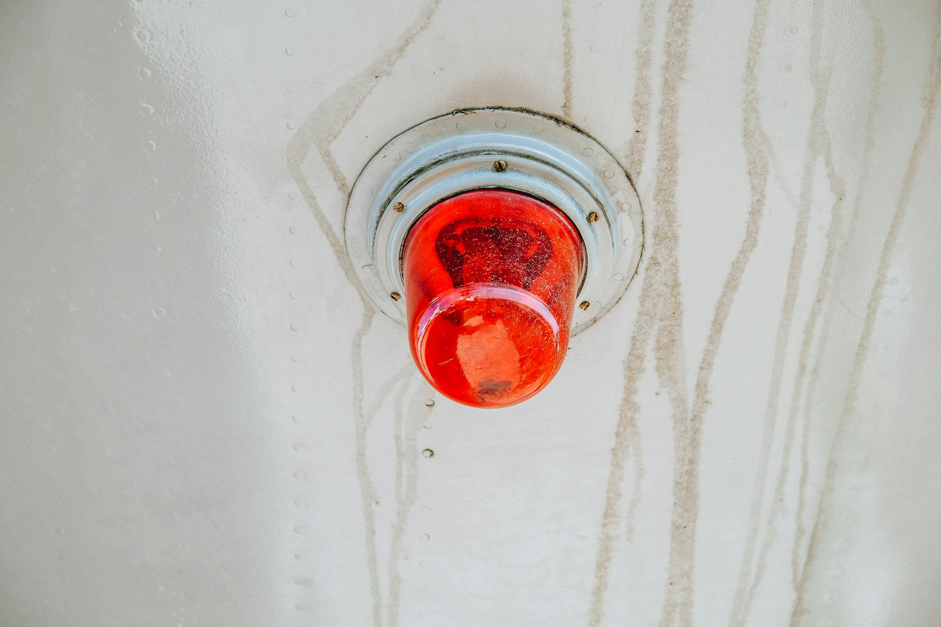 Modern red light therapy device glowing in a clean bathroom setting