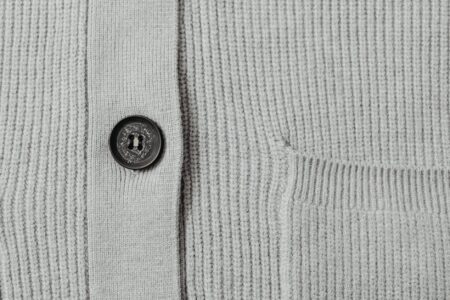 Professional woman wearing a textured cardigan in a modern office setting