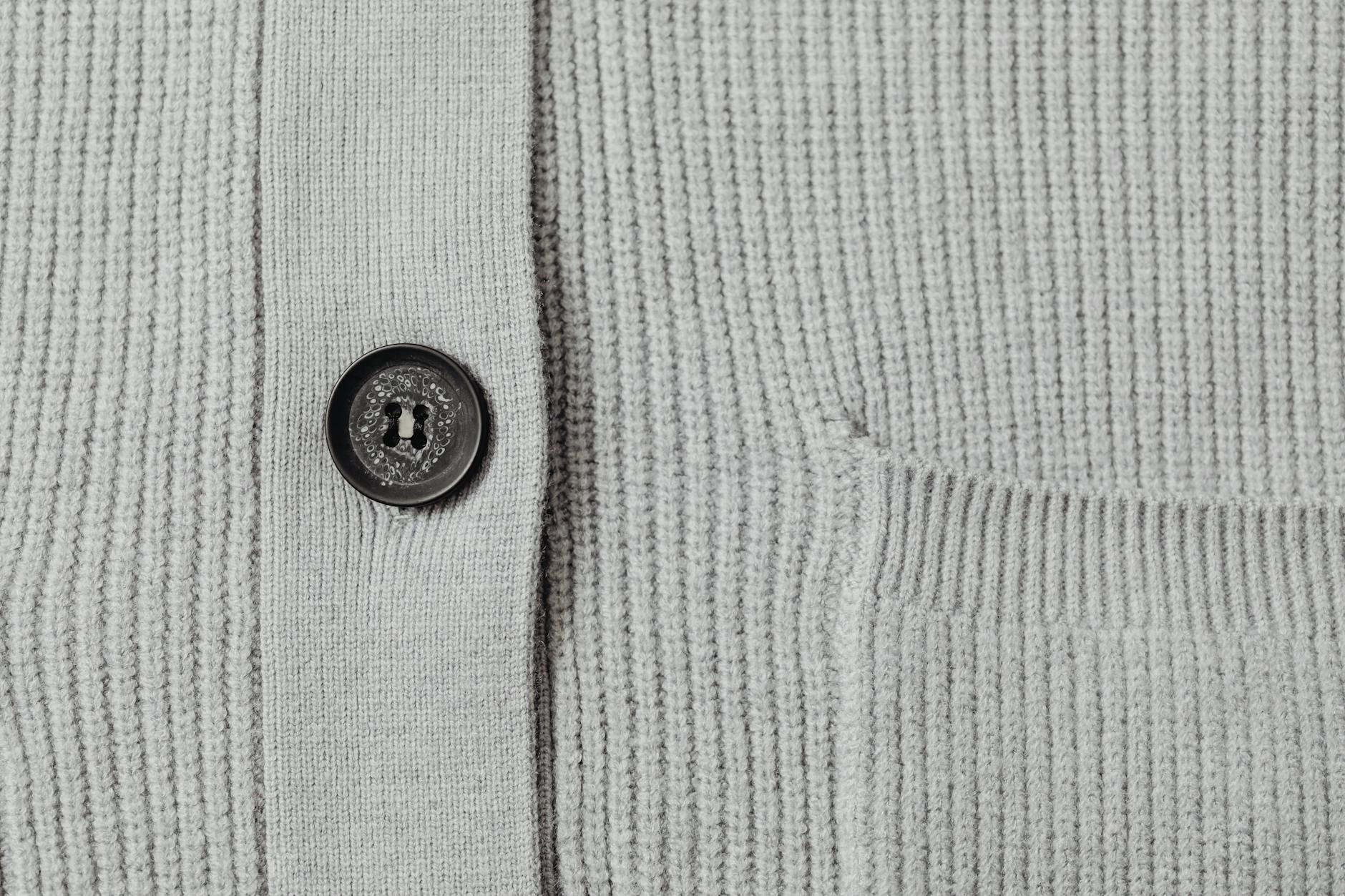 Professional woman wearing a textured cardigan in a modern office setting