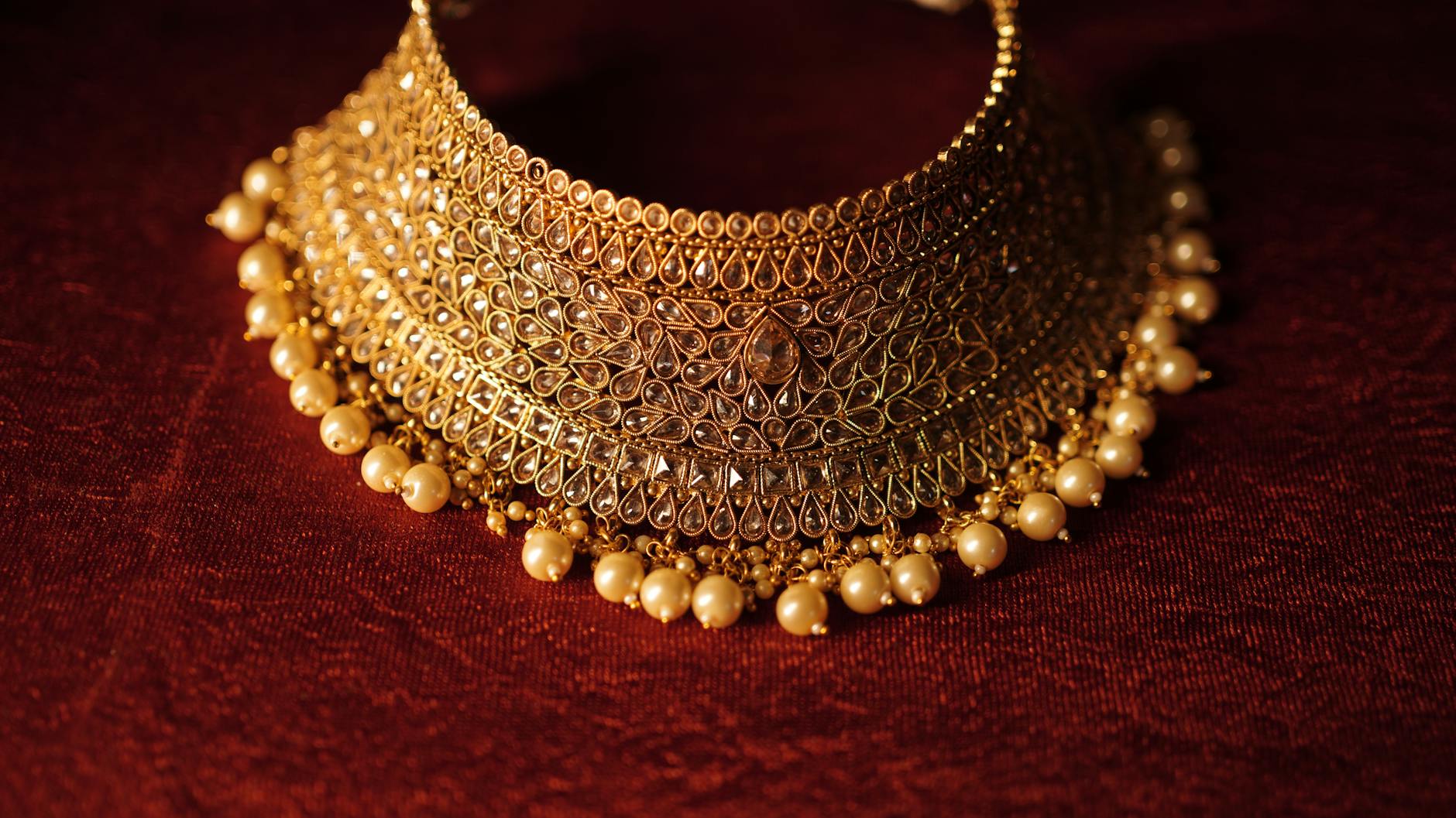 Close-up view of bold gold statement jewelry pieces including chains and rings