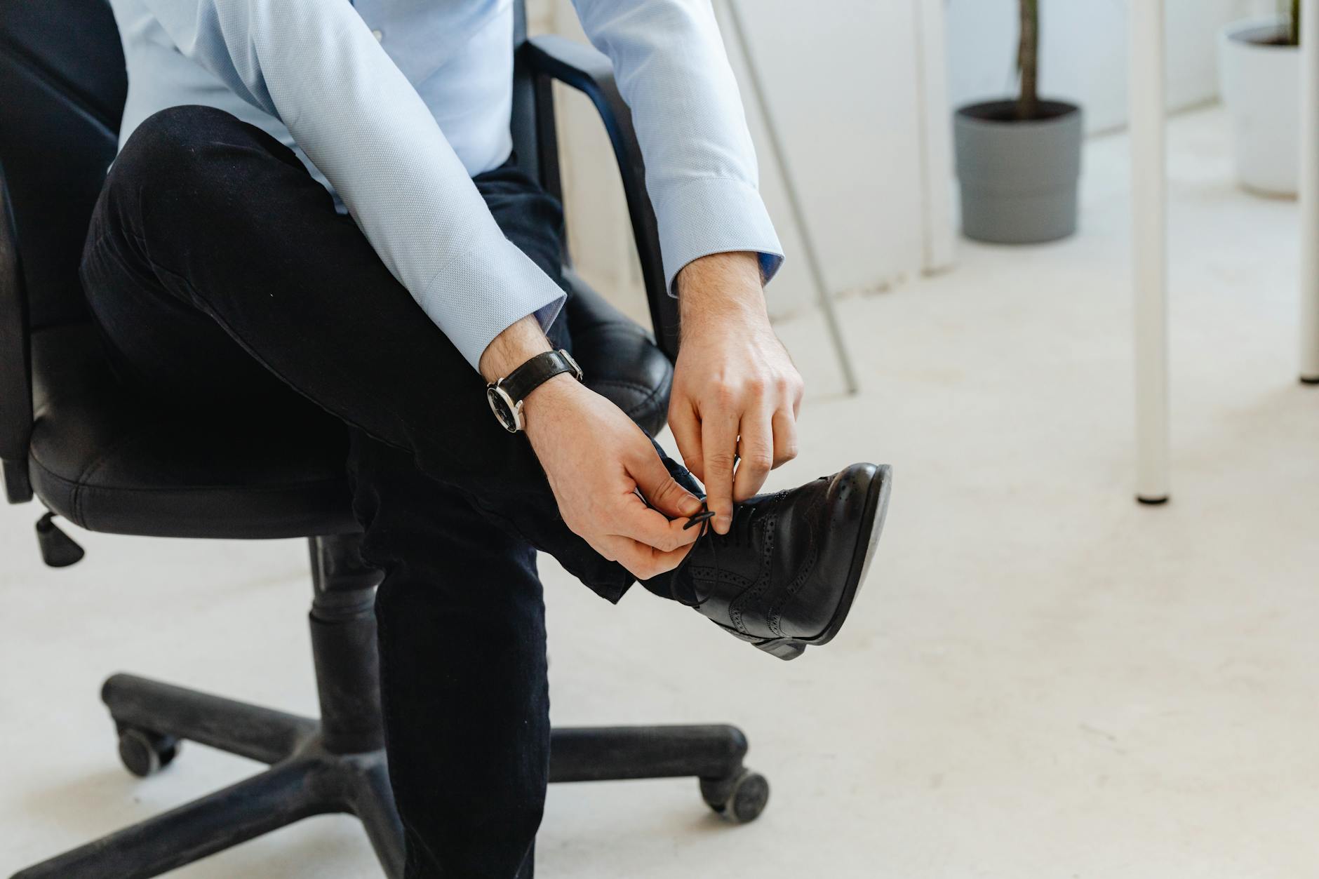 Professional woman's feet wearing stylish hiking boots in modern office setting