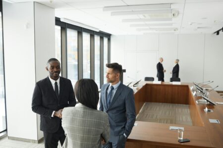 Professional business meeting in modern conference room with executives around table