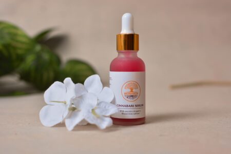 Glass serum bottle with dropper containing pregnancy-safe skincare product on clean background