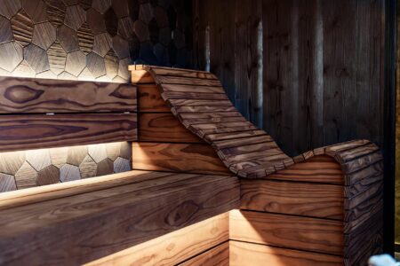 Person wearing LED light therapy mask with red lights illuminating face during skincare treatment