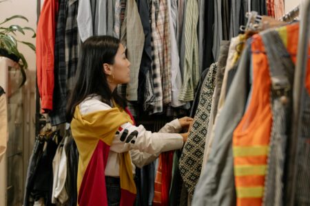 How Gen Z Is Transforming Thrift Shopping Into Luxury Experiences Colorful vintage clothing hanging on racks in a well-organized thrift store