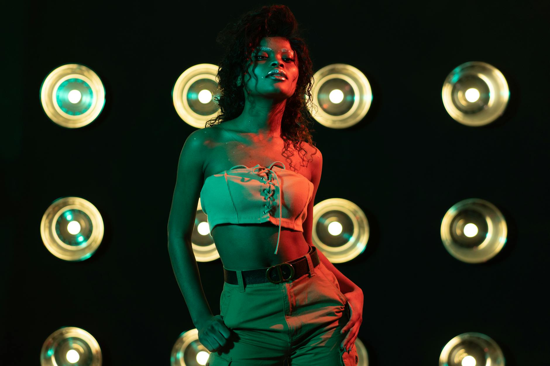 Fashion model wearing statement earrings with simple black outfit