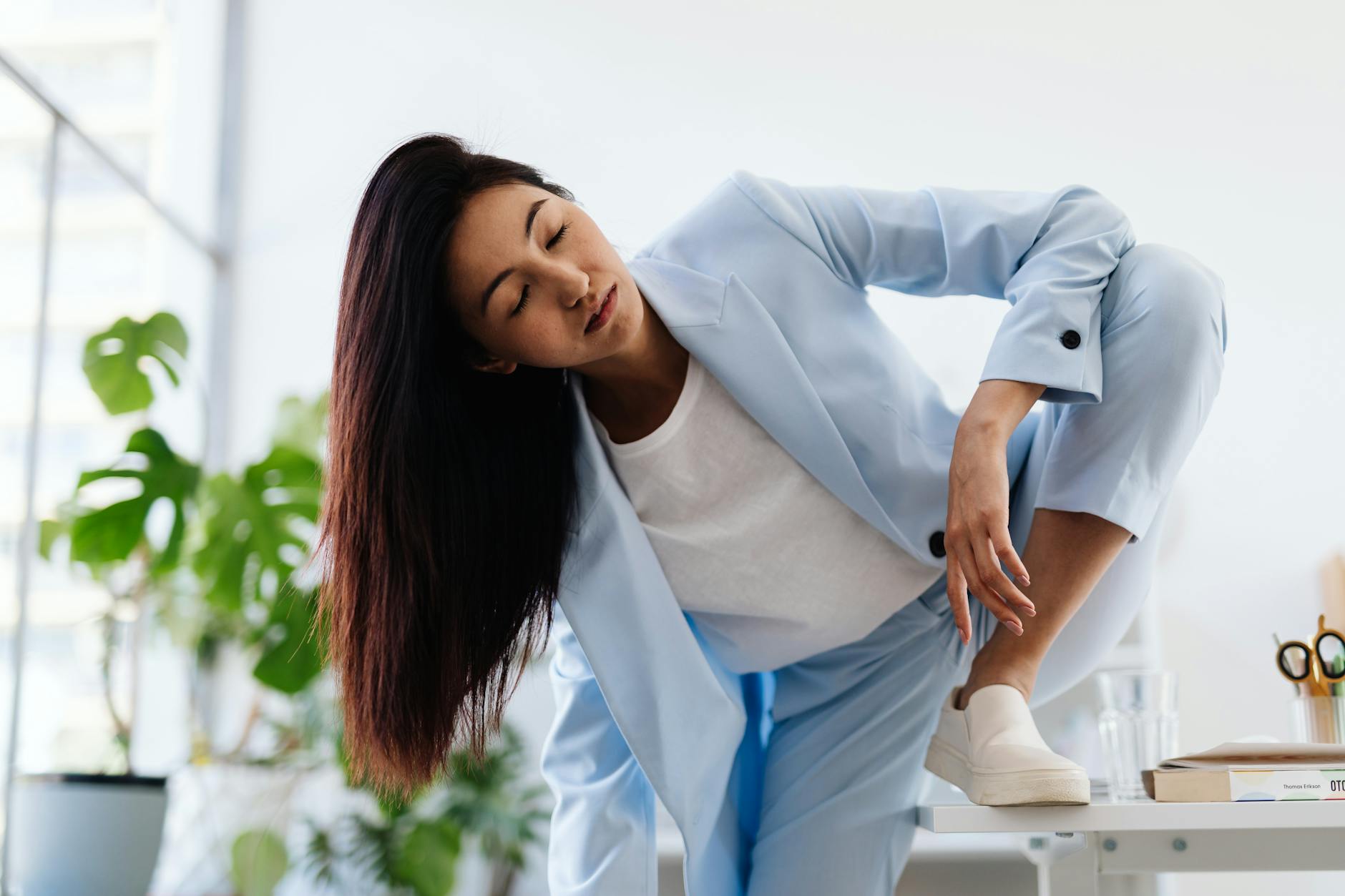 Professional woman wearing tailored trousers and blazer with flat shoes