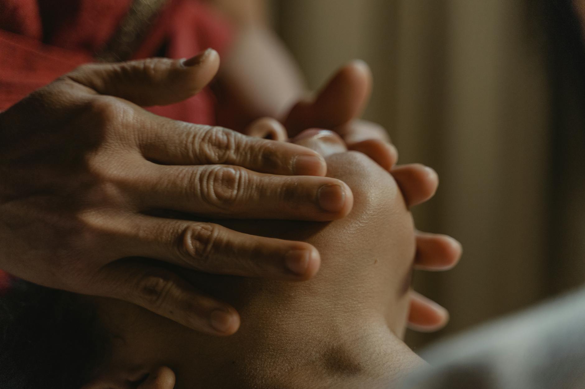Gentle facial massage technique being performed on relaxed client