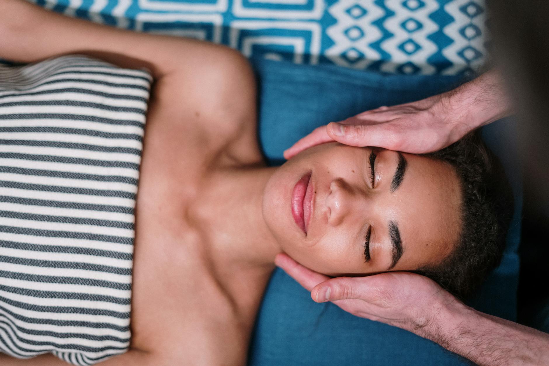 Close-up of facial massage therapy being performed on woman's face