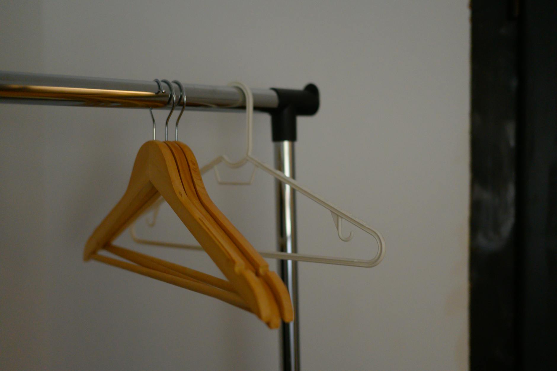 High-end clothing pieces hanging on minimalist clothing rack in boutique setting