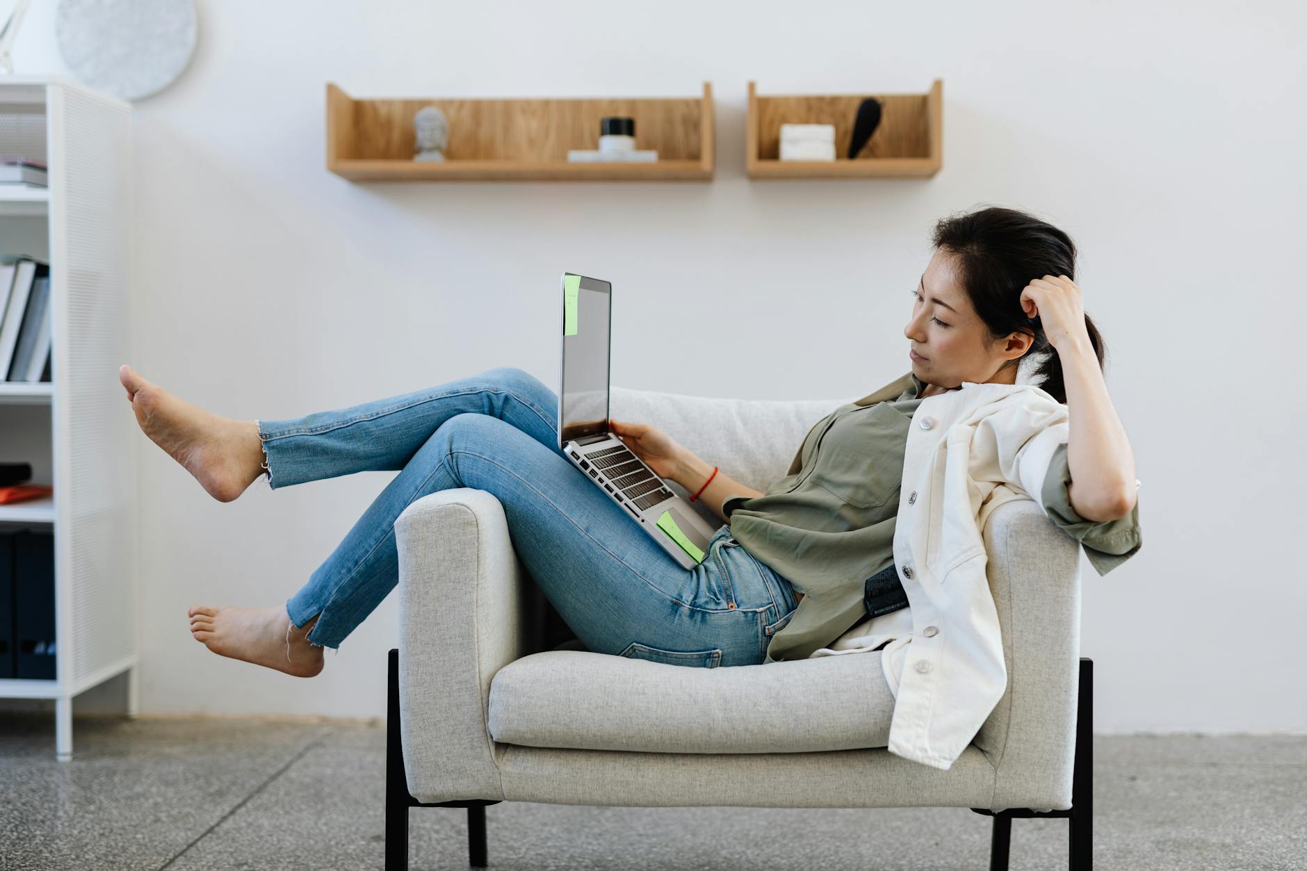 Professional worker in comfortable clothing at a modern office desk with multiple monitors
