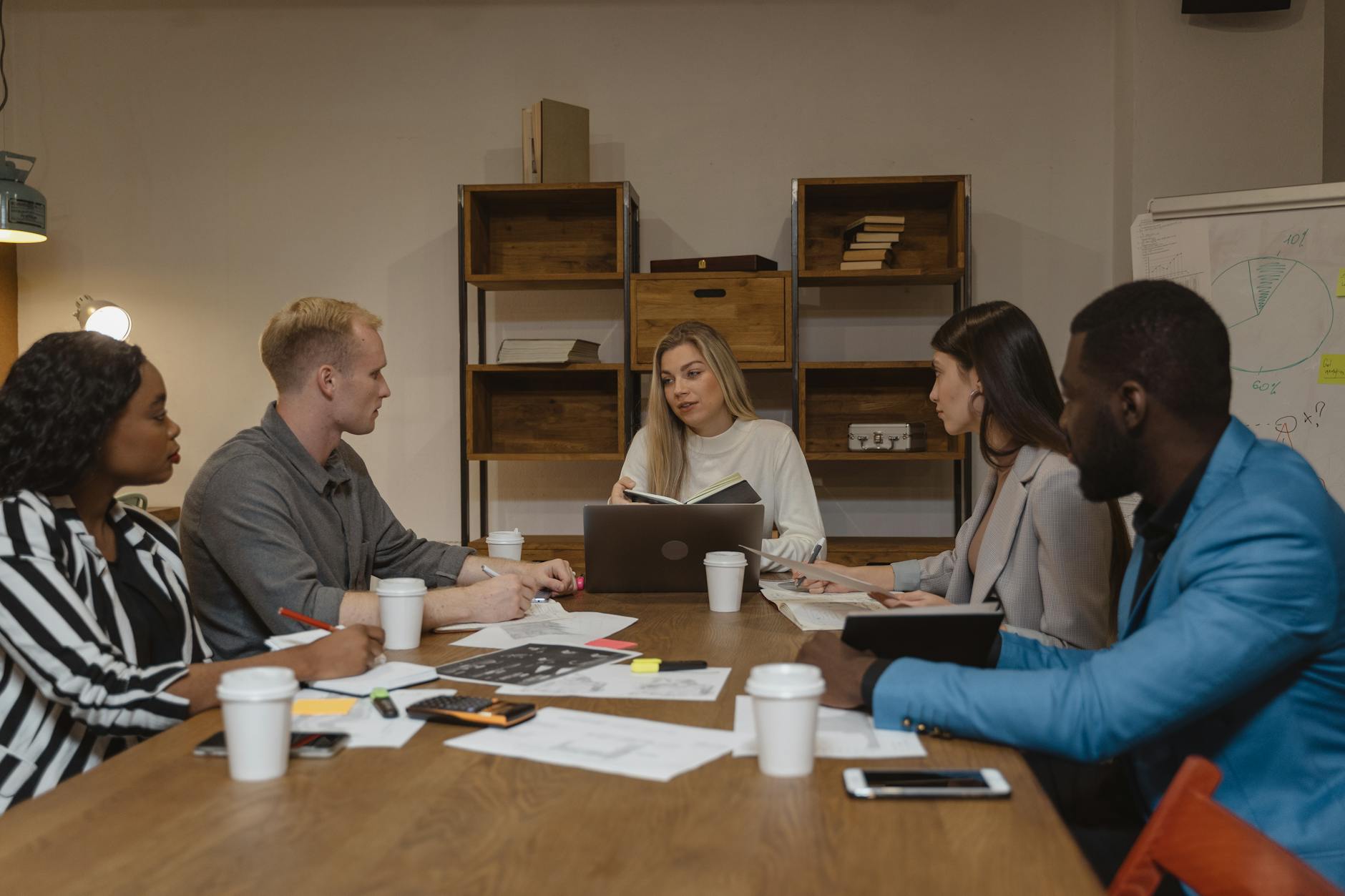 Business professionals in meeting room wearing aviation-inspired navy and burgundy business casual attire