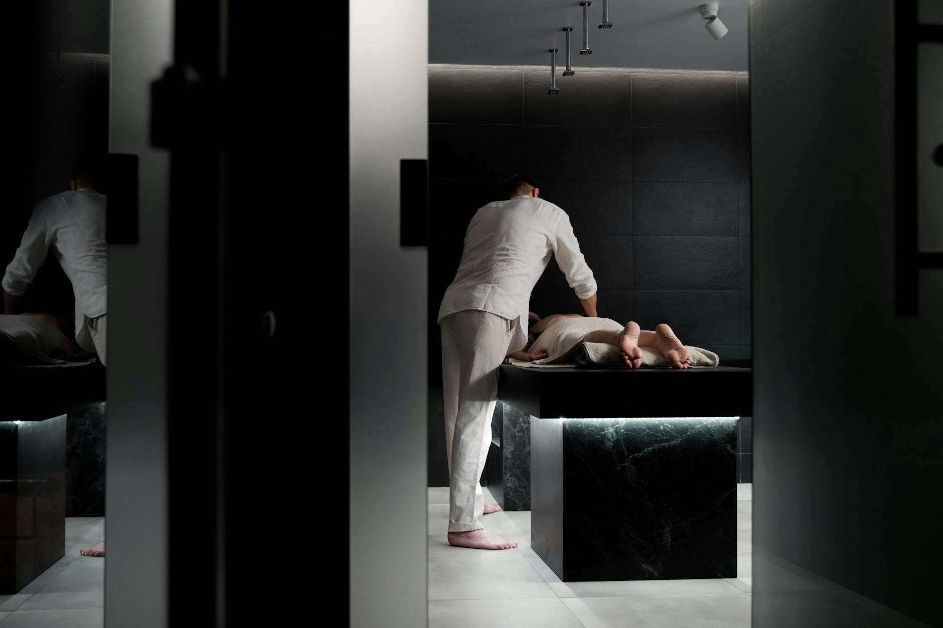 Professional spa treatment room with heated surfaces and wellness amenities for relaxation treatments