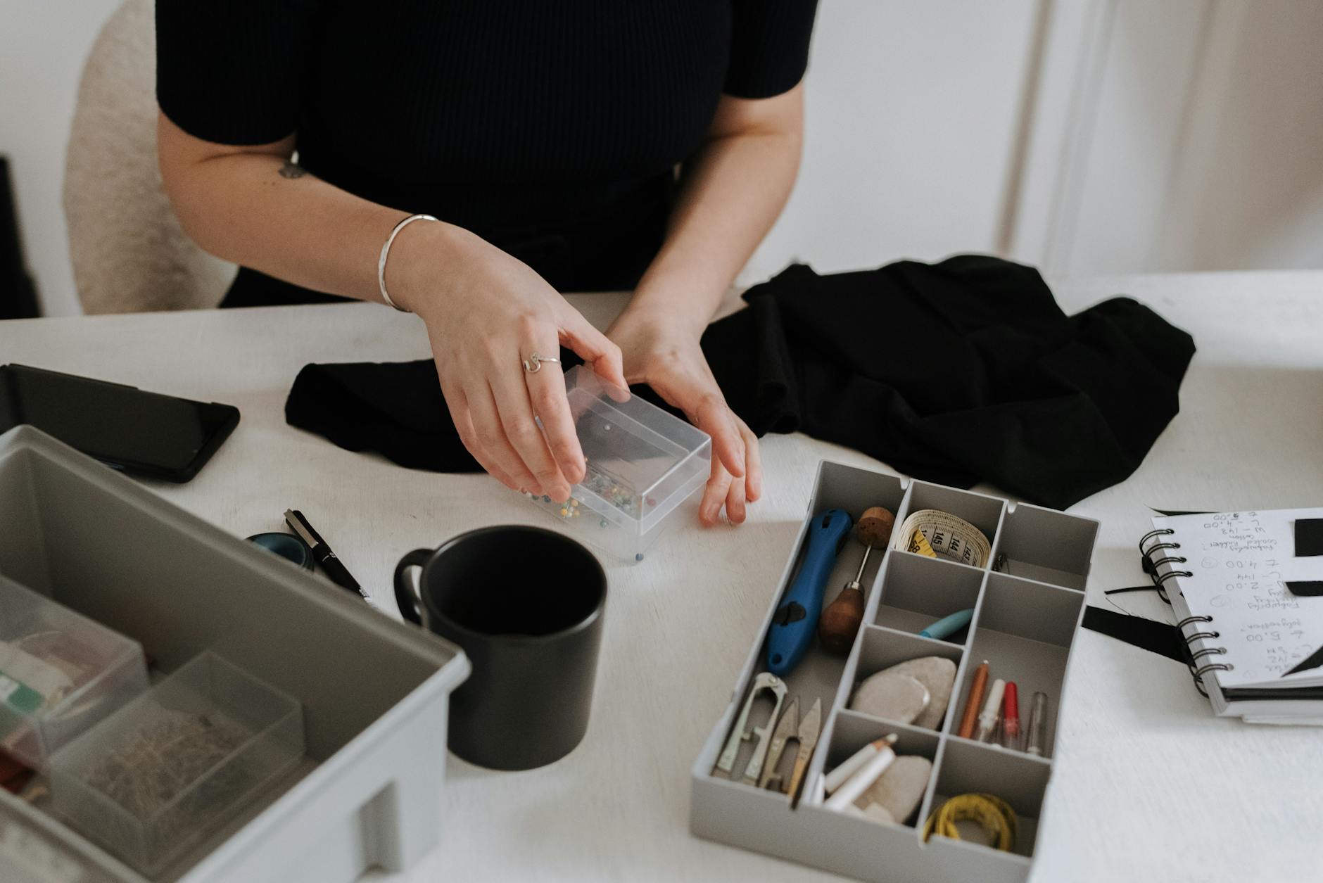 Designer's workspace with fabric swatches, sketches and sewing tools