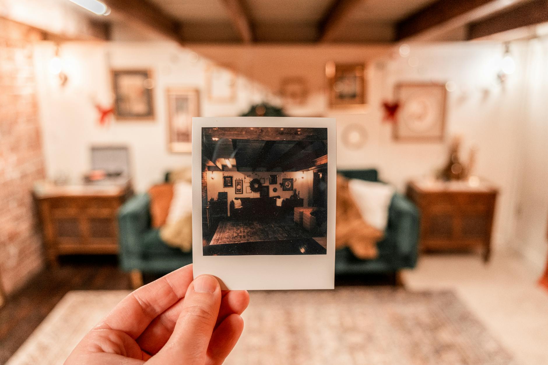 Instant film photos scattered on table with vintage camera