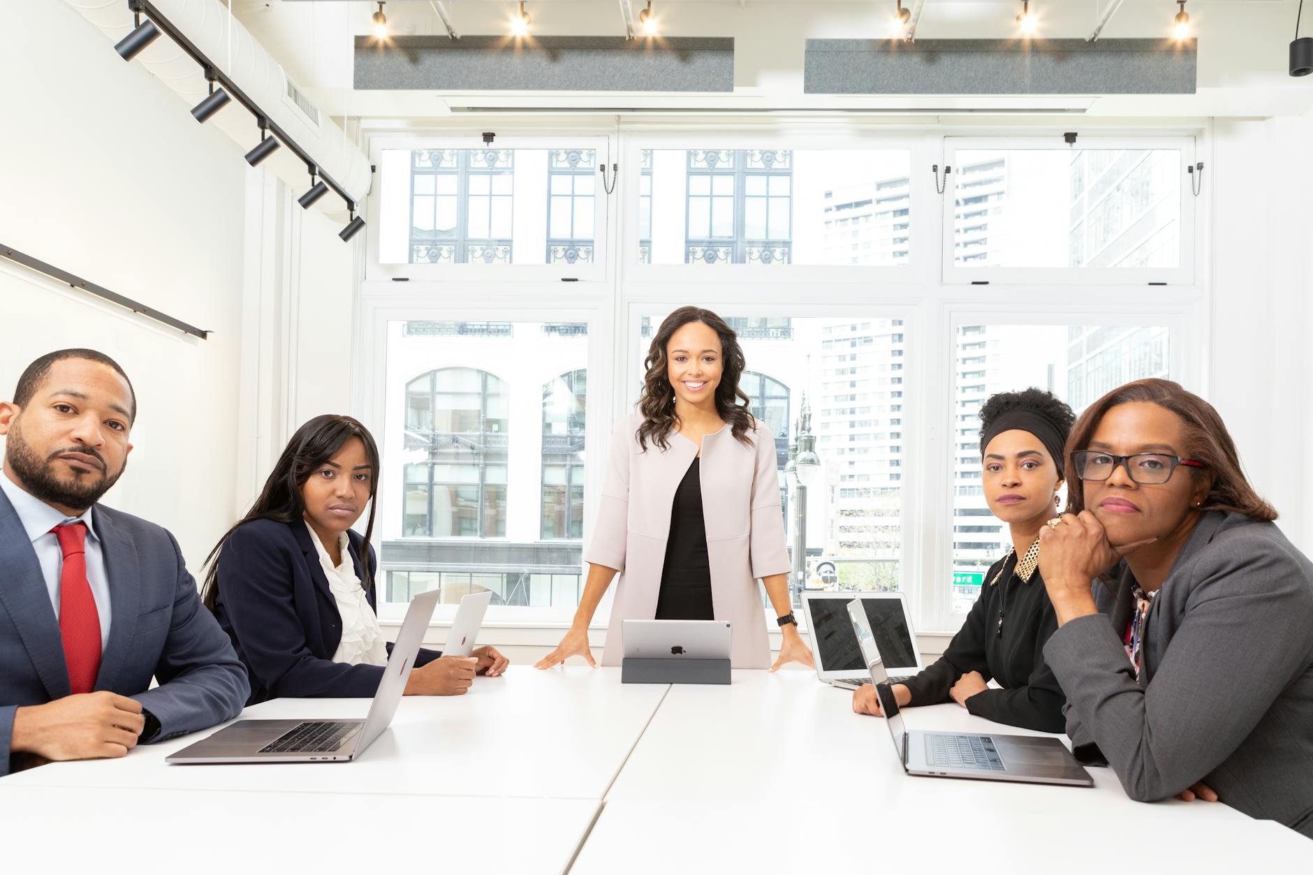 Business professionals in meeting room wearing contemporary minimalist attire