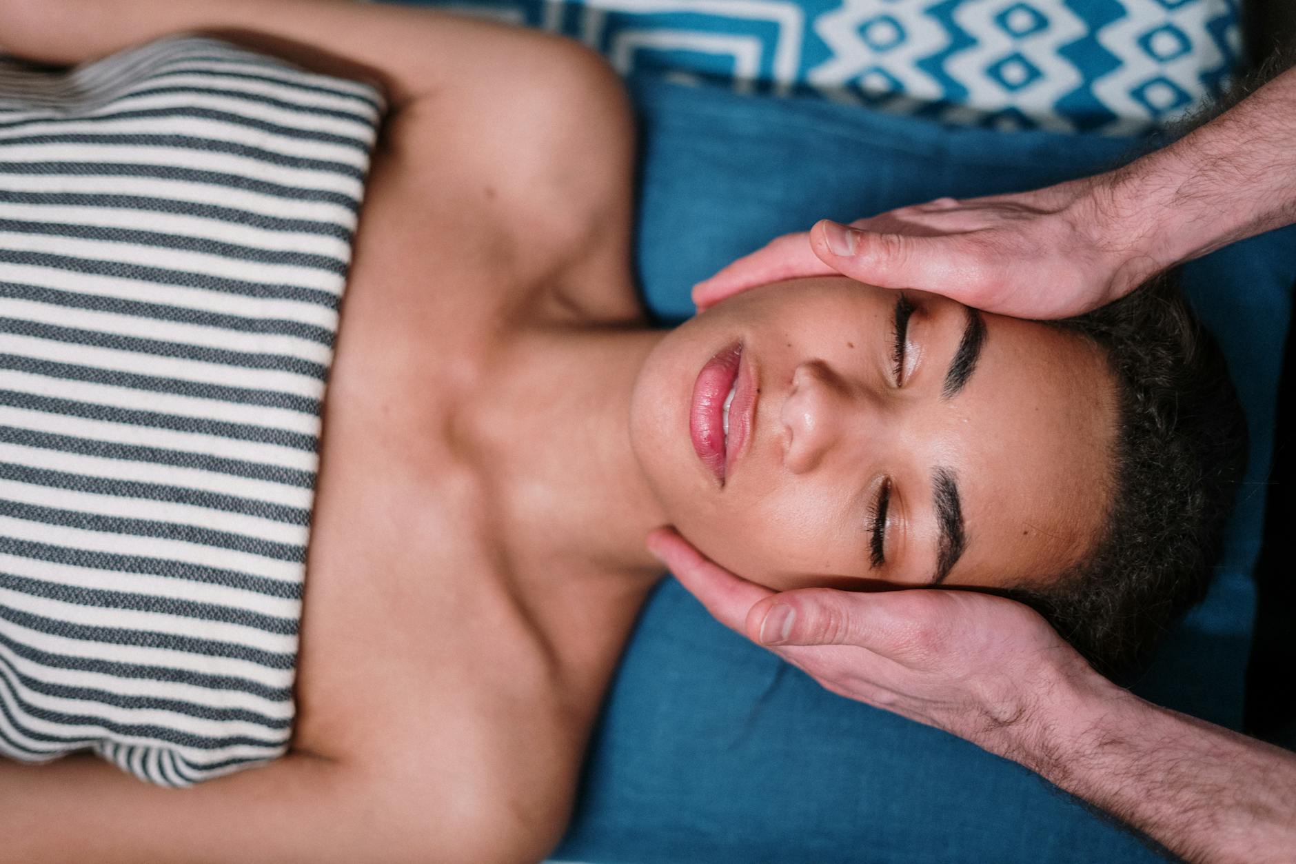 Woman performing self-facial massage using gentle circular motions with hands