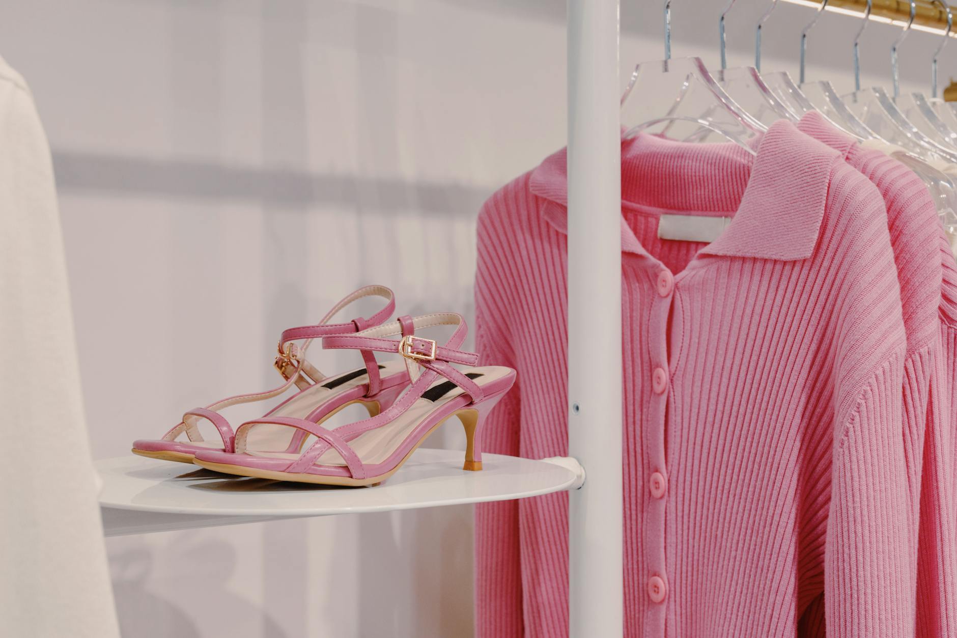 Modern fashion rental showroom with organized clothing displays and digital interfaces