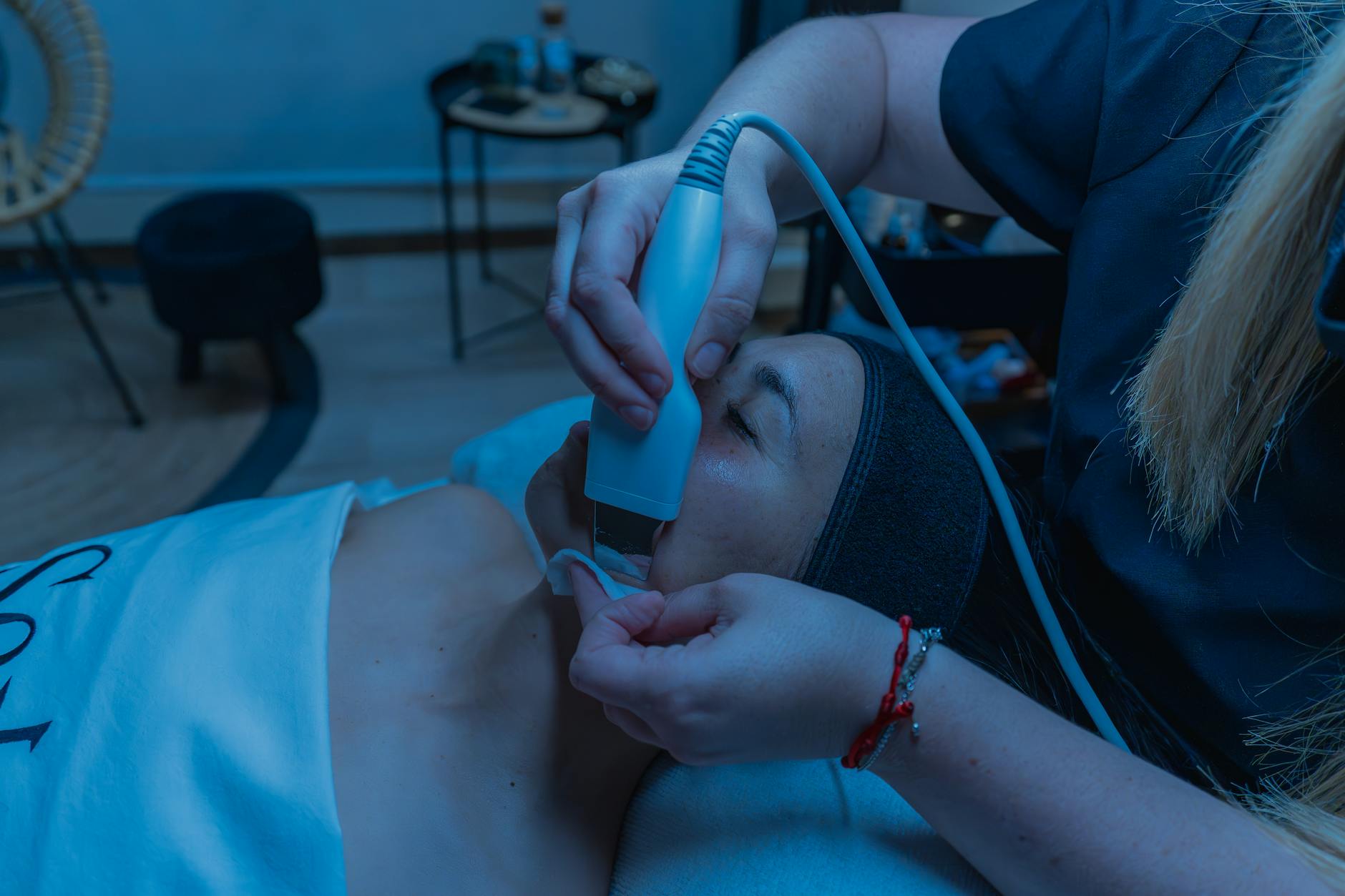 Modern LED face mask device on white background showing sleek design and multiple light panels