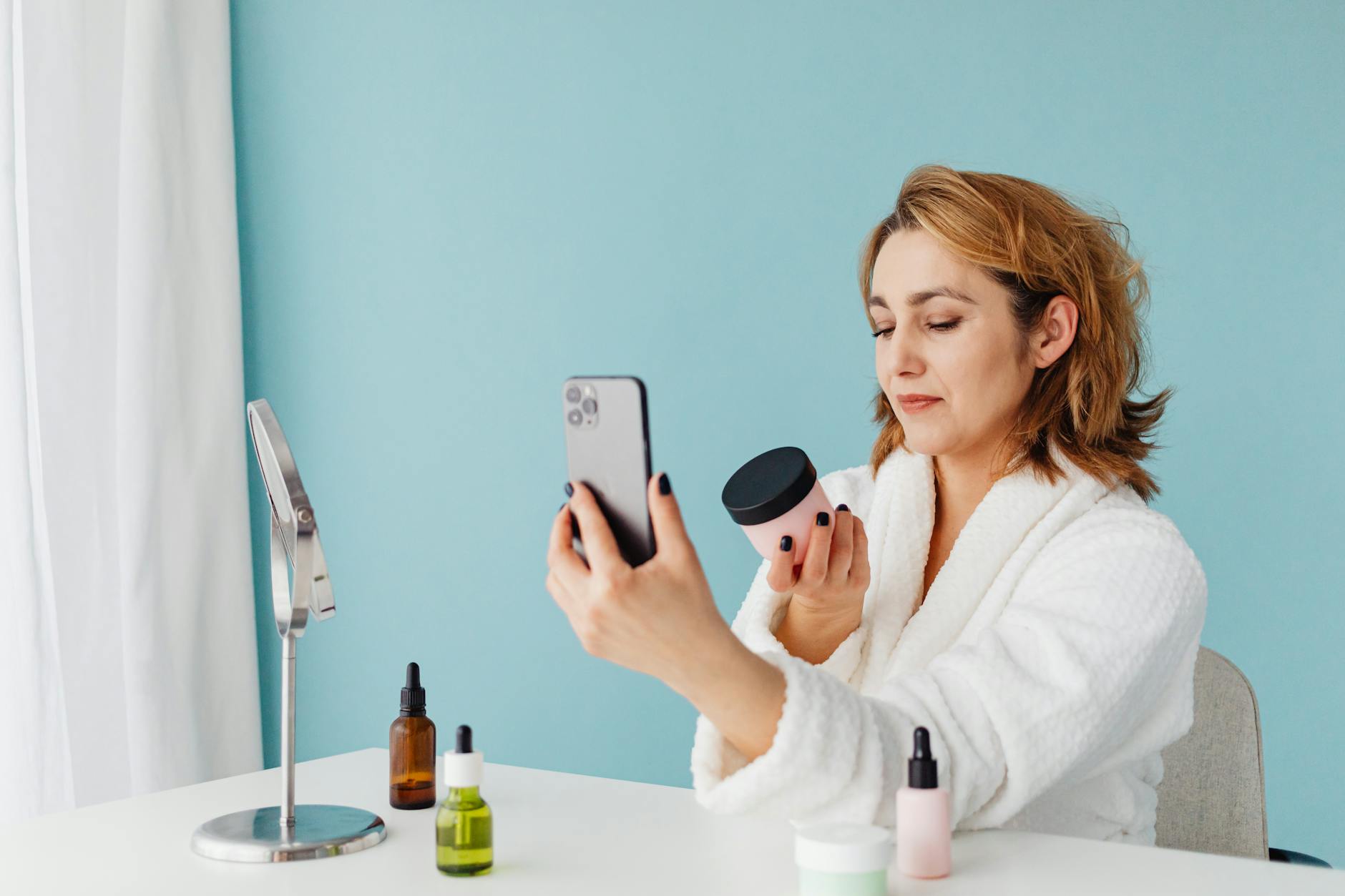 Young woman taking a mirror selfie showing styled hair with decorative accessories