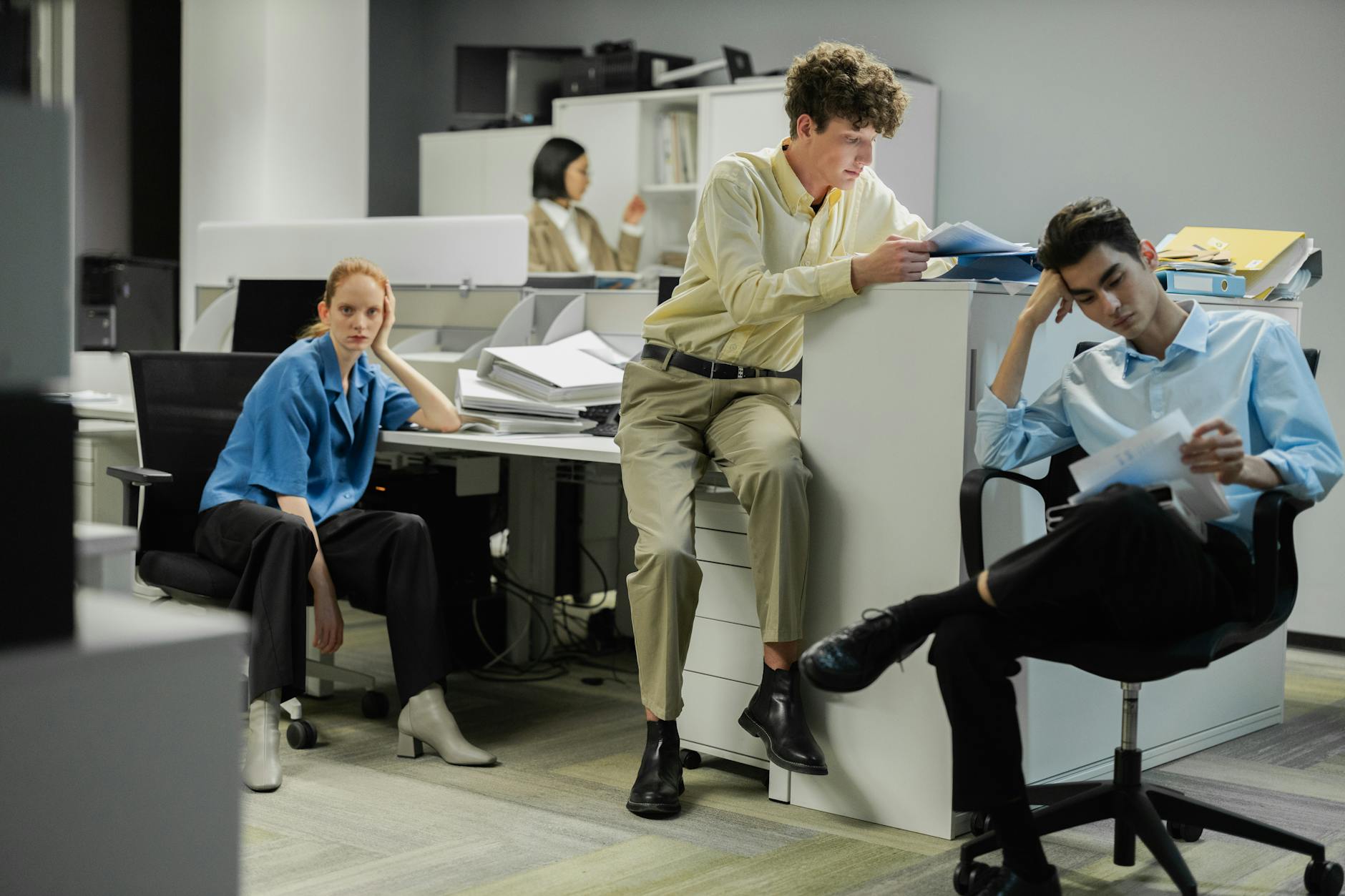 Contemporary office environment with young professionals in modern business casual clothing