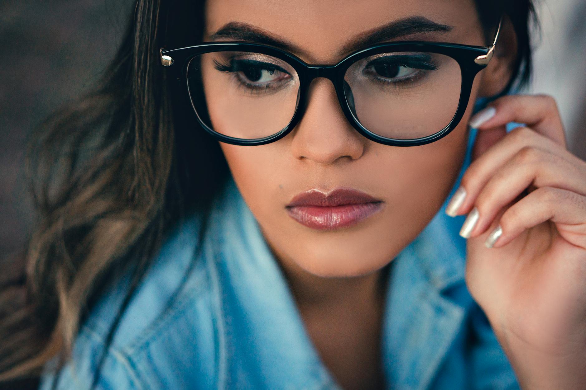 Young woman wearing stylish vintage-style eyeglasses in natural lighting