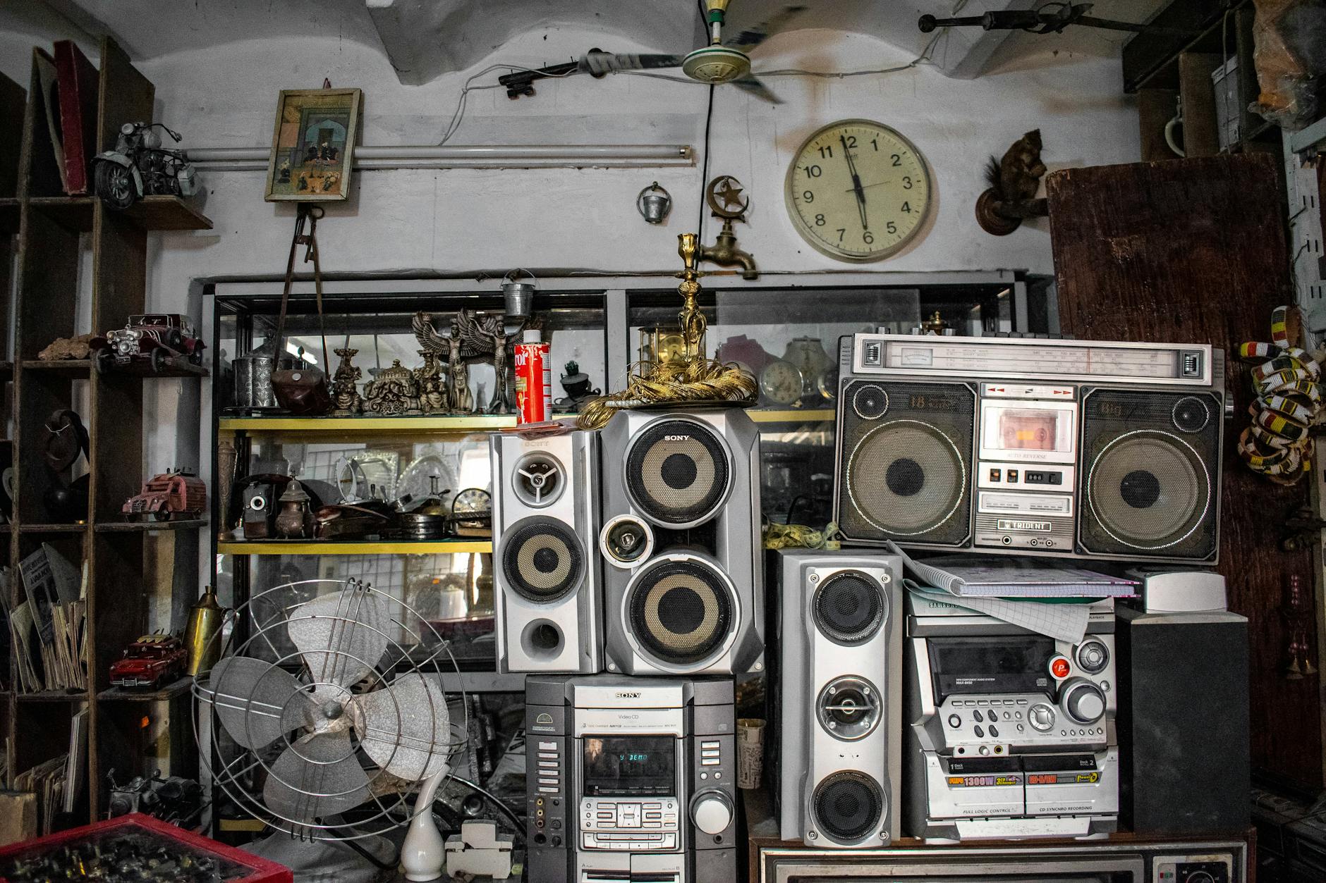 Vintage items and accessories displayed in antique shop with warm lighting