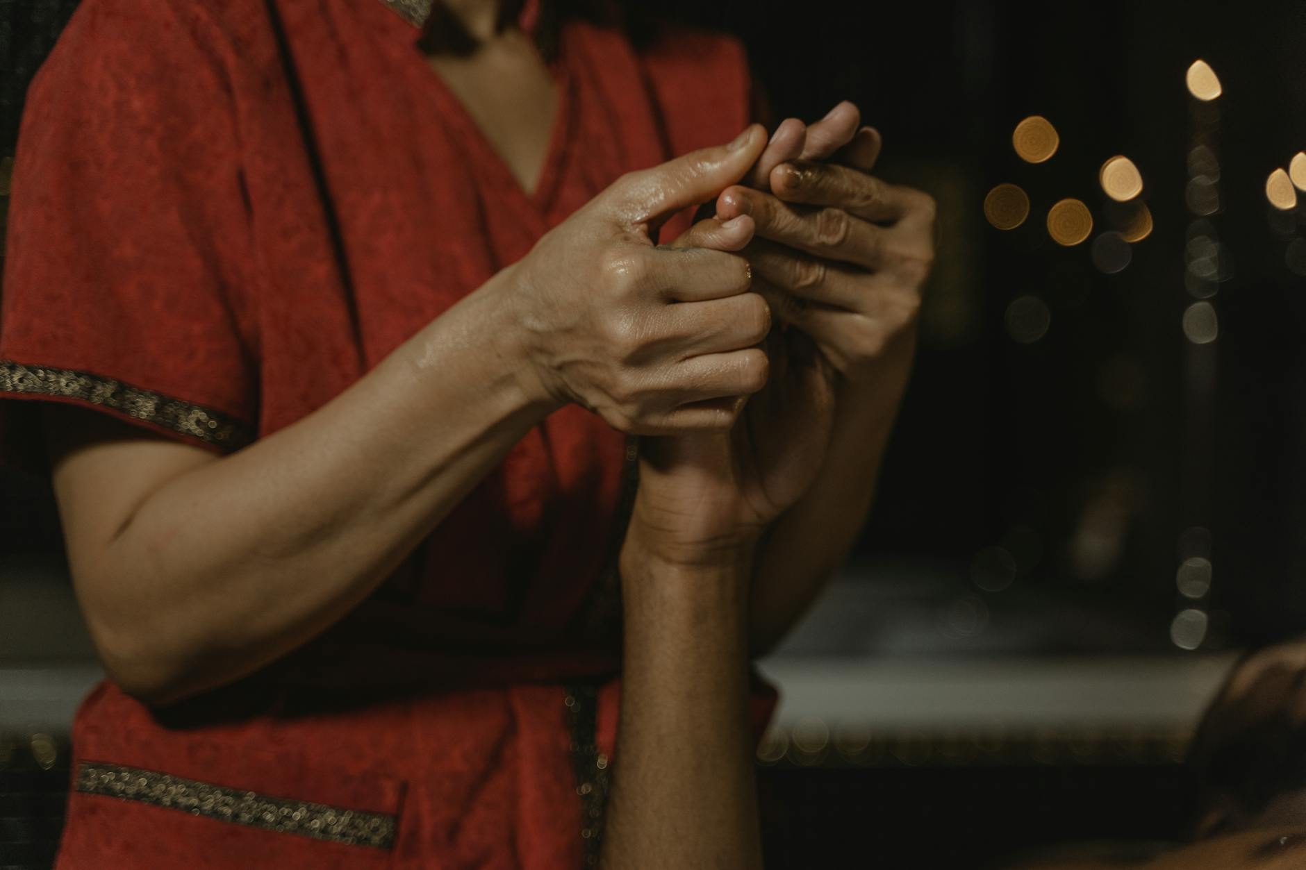 Hands positioned over person during energy healing therapy session