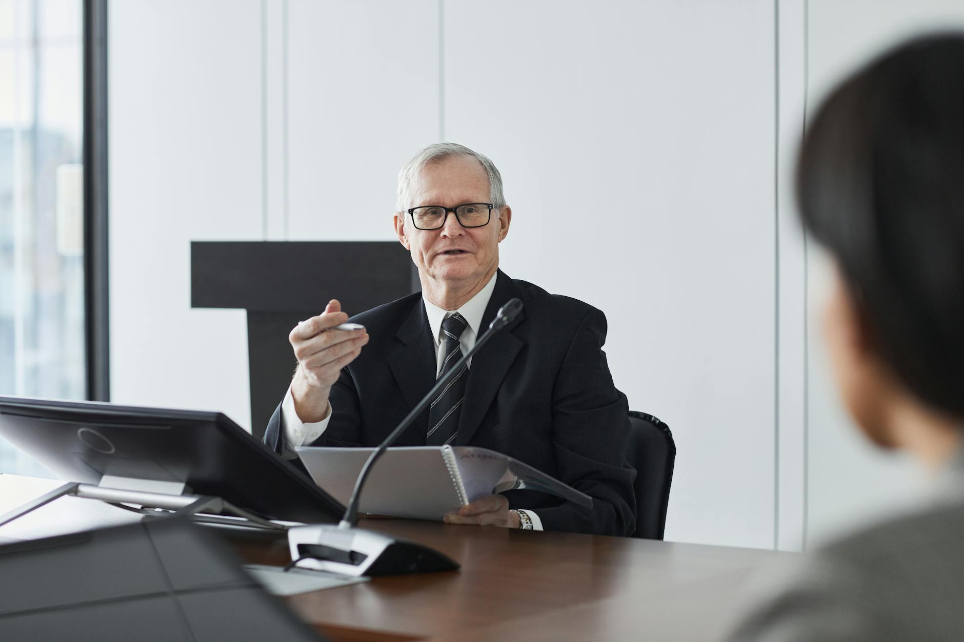 Business executive giving presentation to audience in modern conference room