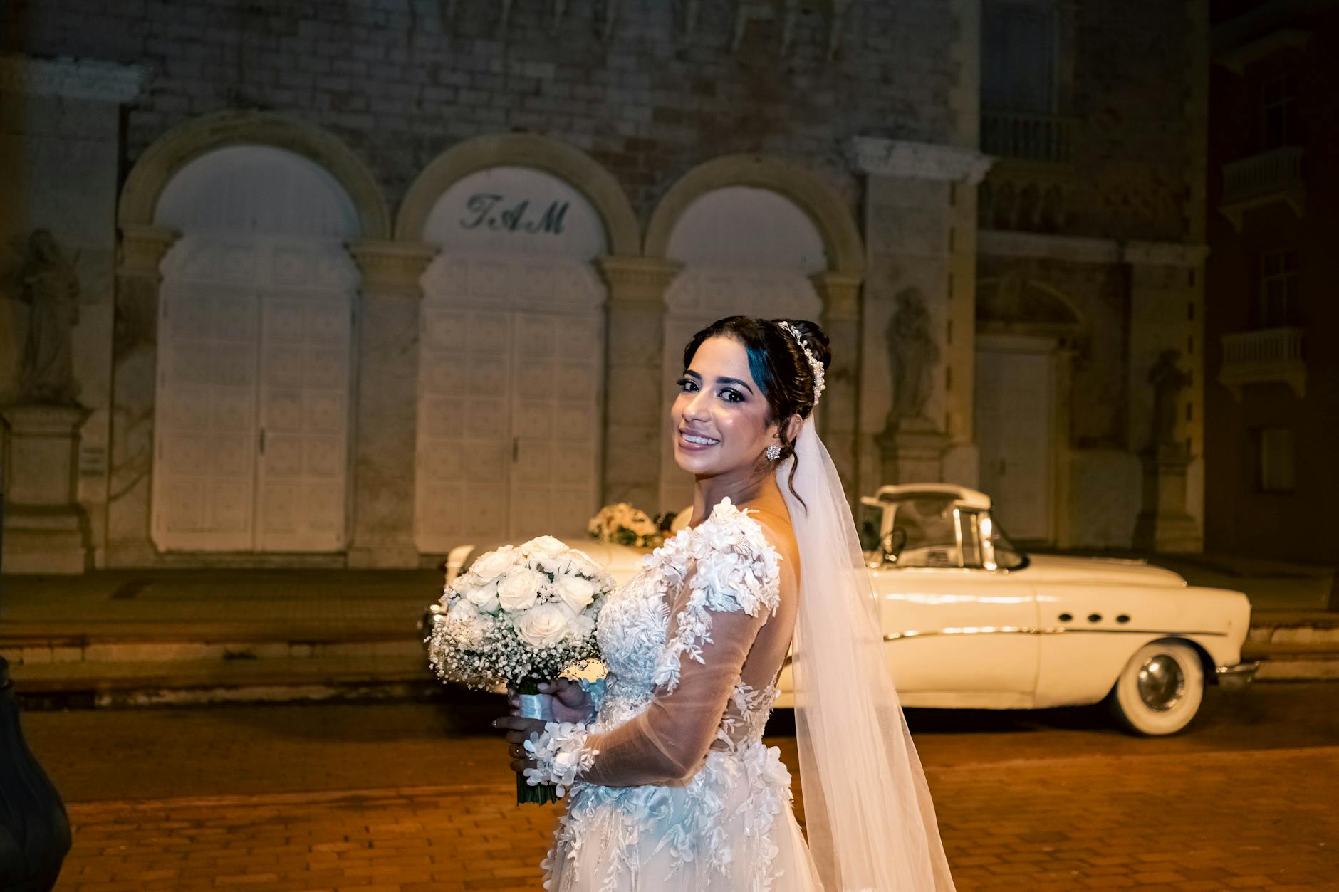 Bride in elegant vintage-style wedding dress posing outdoors