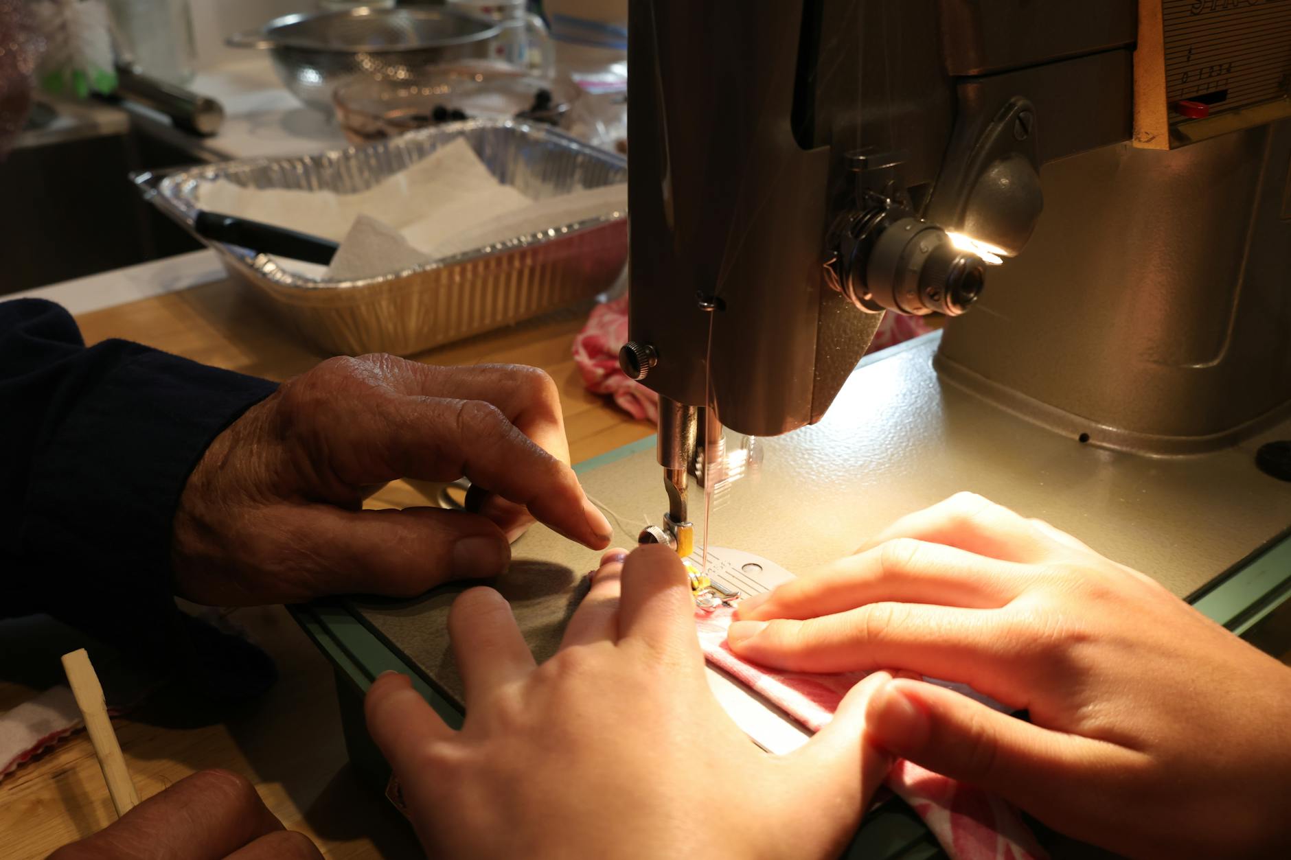 Adults attending a sewing workshop in a bright, modern craft studio setting