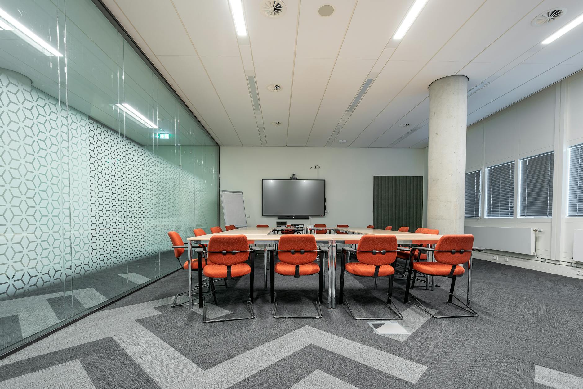Modern conference room with professionals in smart casual attire during business meeting