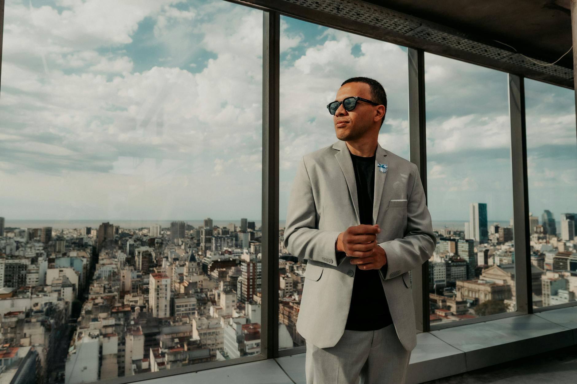 Executive in tailored suit walking through modern office building