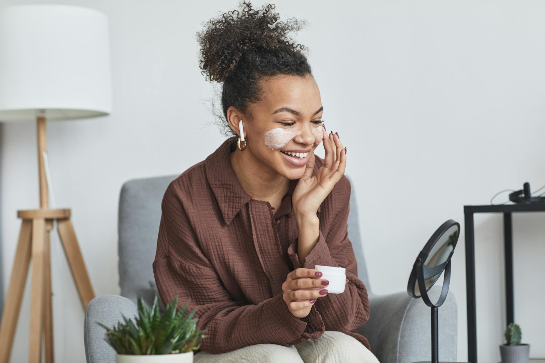 Woman applying skincare products as part of self-care routine at home