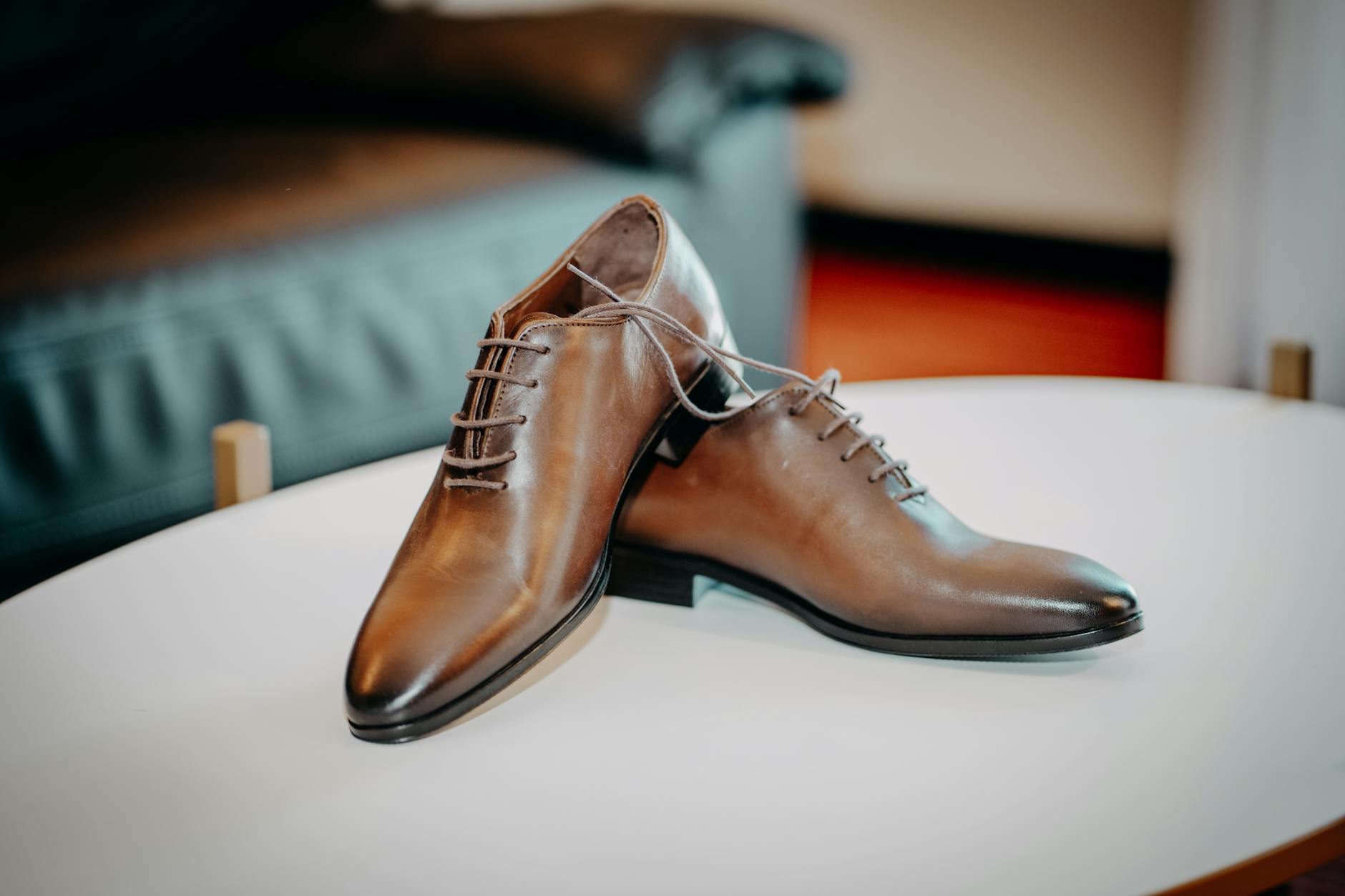 Classic brown leather oxford shoes on wooden floor, showcasing traditional footwear that bridges academic and professional style