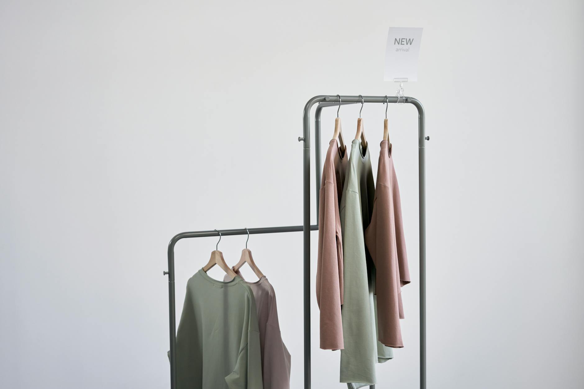 Clean minimalist fashion pieces laid out flat showing capsule wardrobe coordination
